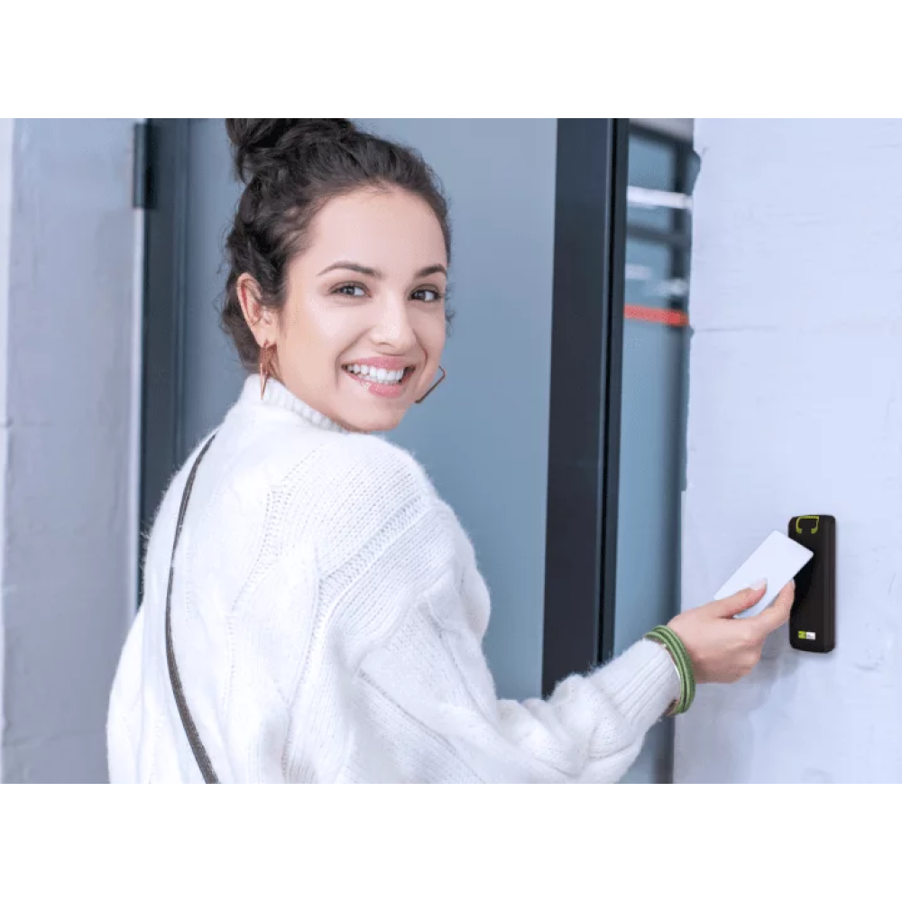 Woman holding a keycard to open a door